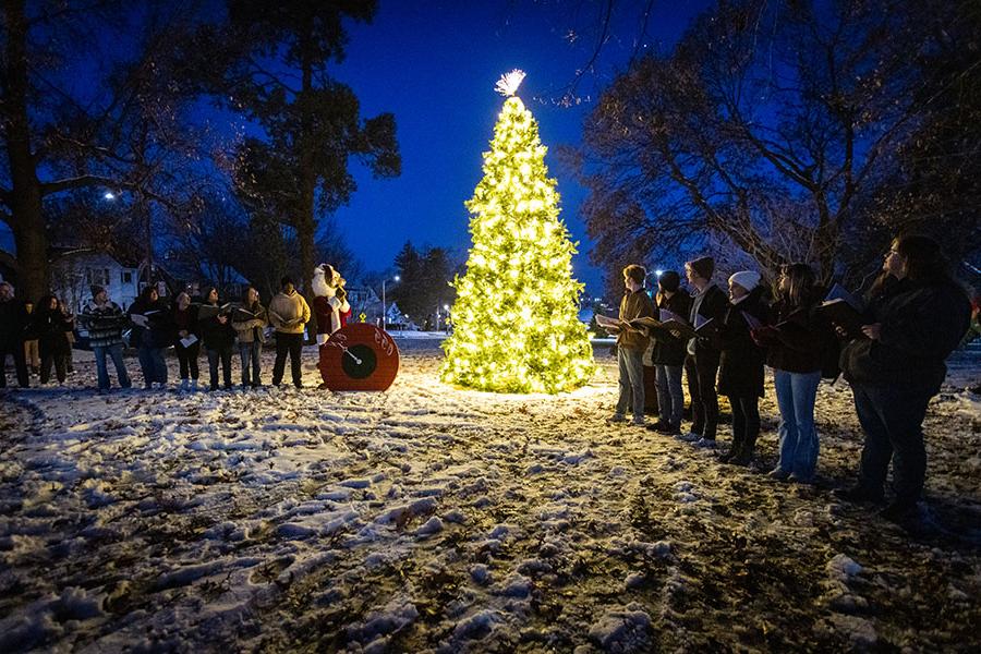 The Madraliers sang after Bobby Bearcat turned a switch to light a Christmas tree Tuesday night on the lawn of the Thomas Gaunt House.