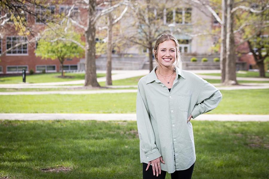 Makenna Johannsen, standing in front of Colden Hall, graduates from Northwest this spring with her bachelor's degree in marketing and communication with an emphasis in public relations. (Photo by Lauren Adams/Northwest Missouri State University)